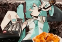 Anime girl with teal hair lounging on a couch while holding a remote and a bottle with snacks nearby.