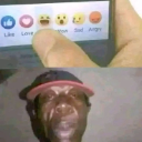 A man with a wide-eyed, confused expression positioned below a finger hovering over Facebook reaction icons.