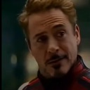 Tony Stark looking sideways with a skeptical and unimpressed expression.
