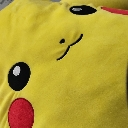 Pikachu face with a subtle, smug smirk and a red cheek.