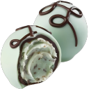 Two mint chocolate truffles with a bite taken out of one to show the creamy interior.