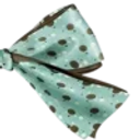 A light blue hair bow with dark polka dots.