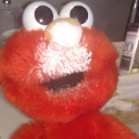 Elmo with wide, unblinking eyes and a gaping mouth looking directly at the camera.