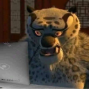 Tai Lung the snow leopard looking at a laptop screen with a shocked and confused expression.