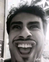 Man with a distorted face and mouth wide open in a black and white photograph.