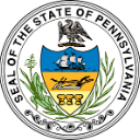 Pennsylvania state seal emblem featuring a shield with a ship and plow on a circular background.