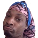 Man with a confused and skeptical facial expression wearing a patterned headwrap.