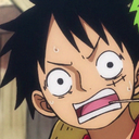 Monkey D. Luffy with wide, bulging eyes and an open mouth in a state of extreme shock.