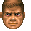 A pixelated man's face with brown hair and skin shifting his eyes from left to right with a serious expression.