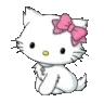 A small white kitten with a large pink bow on its head sits calmly.