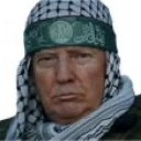 Donald Trump wearing a black and white keffiyeh with a green headband looking directly at the camera.