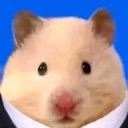 A hamster wearing a suit against a blue background looking directly at the camera.