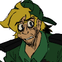 A man with blonde hair and a green shirt looking terrified with wide, bloodshot eyes.