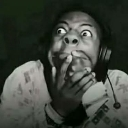 Person with wide eyes and hands covering their mouth in a shocked expression.