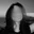 Person with an obscured, blurry face in a black and white photograph.