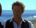 Man puts on black sunglasses in a four-panel sequence against a blue ocean background.