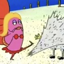 A pink fish character with blonde hair kicks a large white block of ice.