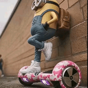 A Minion wearing jeans and a backpack leans against a brick wall while standing on a pink camouflage hoverboard.