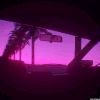 Car interior looking out at a purple and pink sunset with palm trees silhouetted against the horizon.