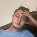 Man looking exhausted with his hand resting on his forehead in a gesture of defeat.