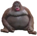 A round, brown ape sitting down with a wide-eyed, open-mouthed expression of shock.