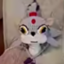 A gray creature with large yellow eyes and a red dot on its forehead stares intensely with a suspicious expression.
