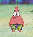 Patrick Star standing with a vacant expression and his tongue sticking out.