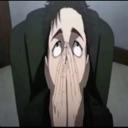 A man with dark hair and a tired expression holds his hands up to his face in a gesture of despair.