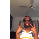 Person wearing sunglasses giving a double peace sign gesture.