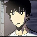 A young man with a blank, expressionless face and dark hair looking directly ahead.