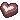 Three brown heart-shaped chocolates with pink centers arranged in a row.