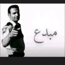 Rick Grimes pointing his finger forward with the Arabic word for creative written next to him.