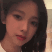 A young woman looking sideways with a skeptical and judgmental expression.
