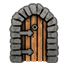 A wooden door with vertical planks and iron hinges set inside a gray stone archway.