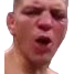 A man with a strained face shouting in an intense, aggressive expression.