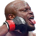 A fighter with a pained expression taking a direct punch to the face from a gloved hand.