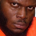 Man looking directly into the camera with an intense, suspicious, and judgmental expression.