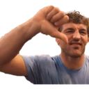 Man giving a thumbs down gesture with a look of disapproval.