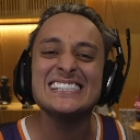 Man wearing a gaming headset showing a wide, teeth-baring grin.