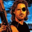 Snake Plissken with an eyepatch holding a firearm with a serious expression.