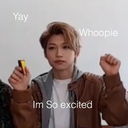 A young man with a neutral face holds up a fist with text overlays saying Yay, Whoopie, and Im So excited.