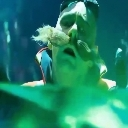 A person with a shocked expression submerged underwater with a green tint.