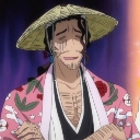 A man wearing a straw hat and a pink patterned kimono looks down with a tired and weary expression.