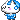 A small white creature with blue hair and a blue outfit blushing with a shy smile.