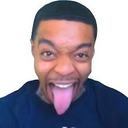 Man with a wide, goofy expression sticking his tongue out towards the camera.