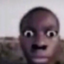Human face with extremely wide, staring eyes and a shocked expression.