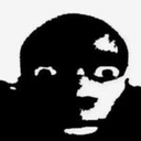 Face with wide, unblinking eyes in a high-contrast black and white style showing intense shock.