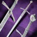 Three ornate silver fantasy swords arranged against a solid purple background.