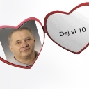A man's headshot inside a red heart locket with the text Dej si 10 on the right side.