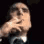 Man in a suit looking upward and exhaling a cloud of smoke in a four-frame sequence.